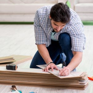 Man laying flooring at home The man laying flooring at home